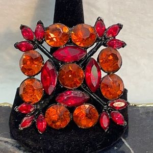 Vtg Edlee red and orange crystal/rhinestone 2.5” brooch w/japanned back. Domed
